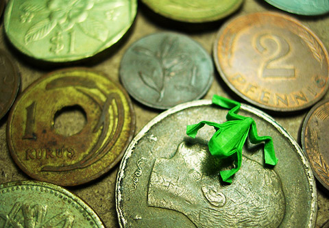 photo of origami from on a bed of coins photo of origami from on a bed of coins