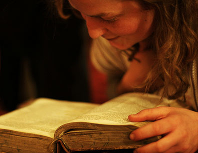 warm light as a woman reads a book